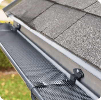 Gutter guards installed on residential gutters to reduce leaf buildup
