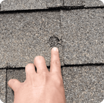 an image showing damage to a roof that should be covered by roofing insurance
