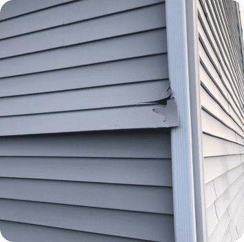 image of some vinyl siding that has been damaged