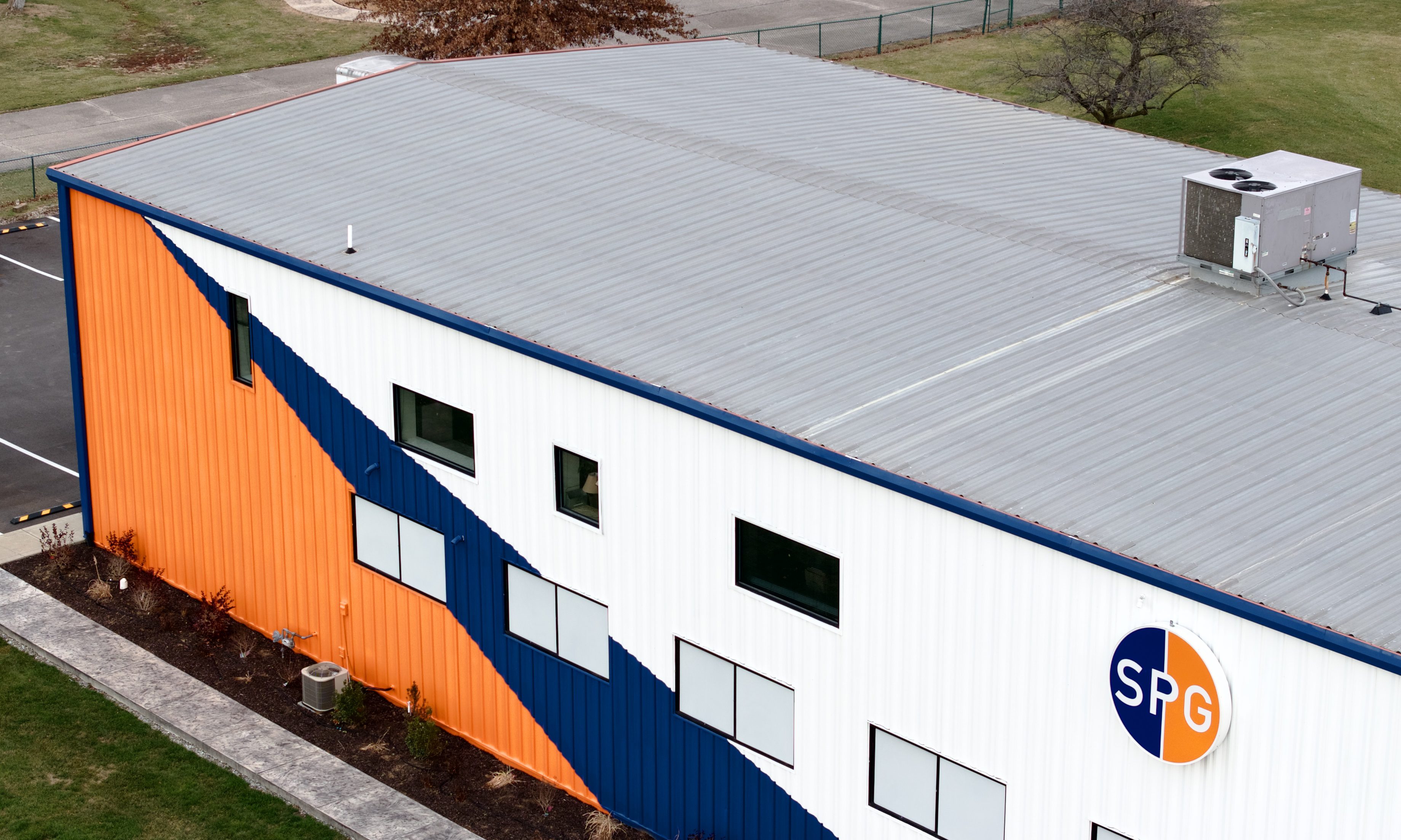 Aerial perspective of roof top and building with commercial siding