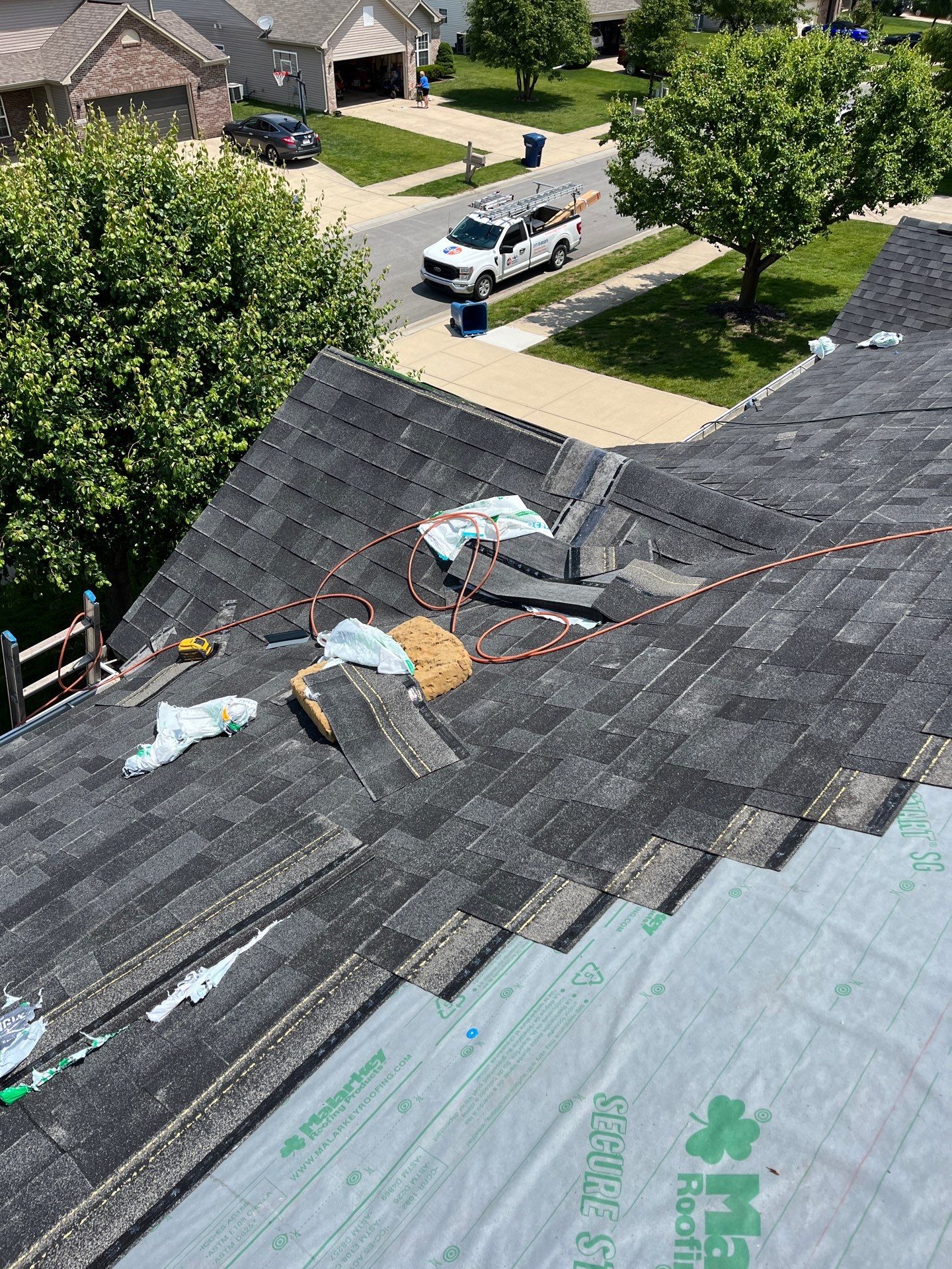 Crew installing a new asphalt shingle residential roof on a home in Indianapolis