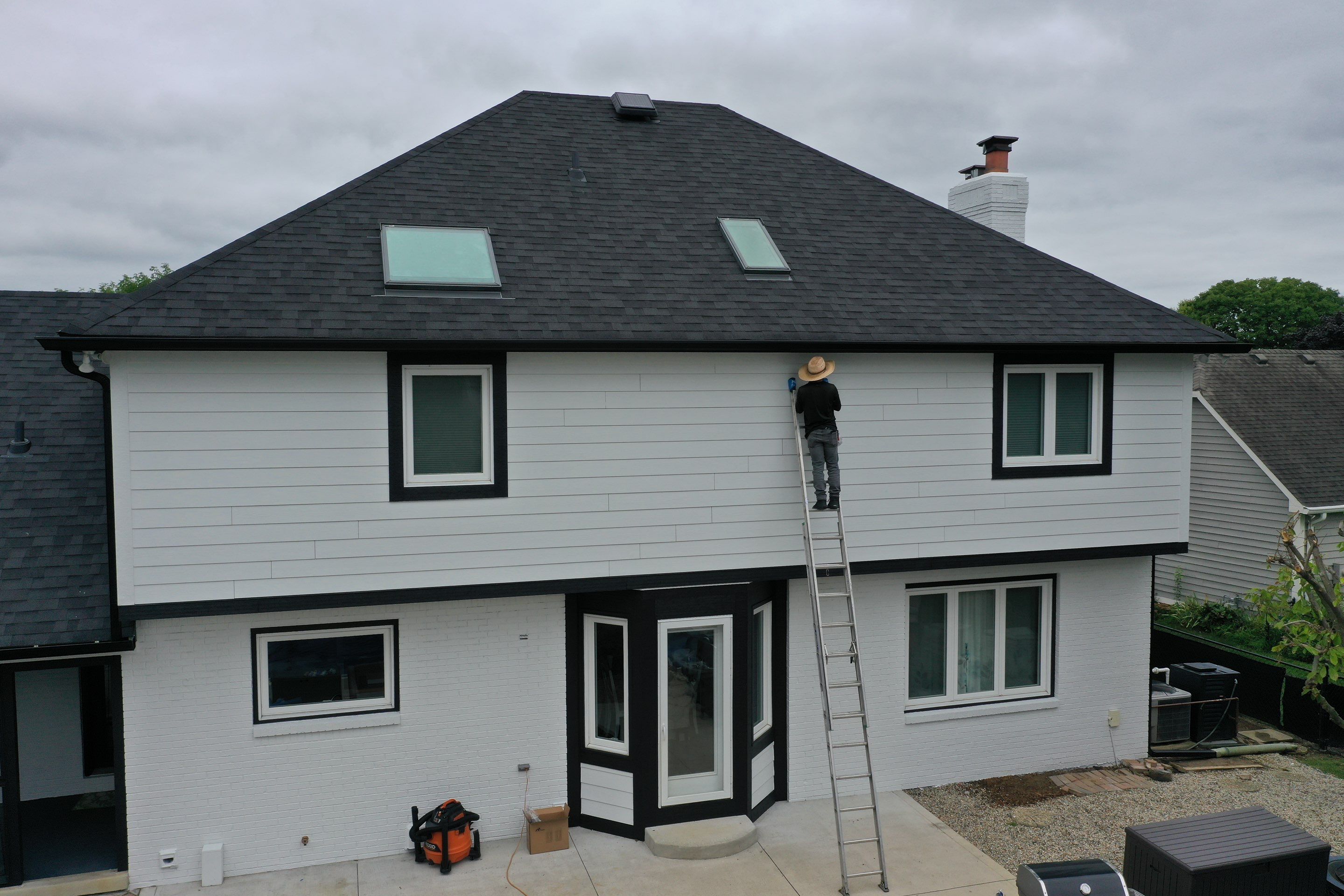 Trim and masonry painted with Sherwin Williams Loxon system showcases the exterior transformation